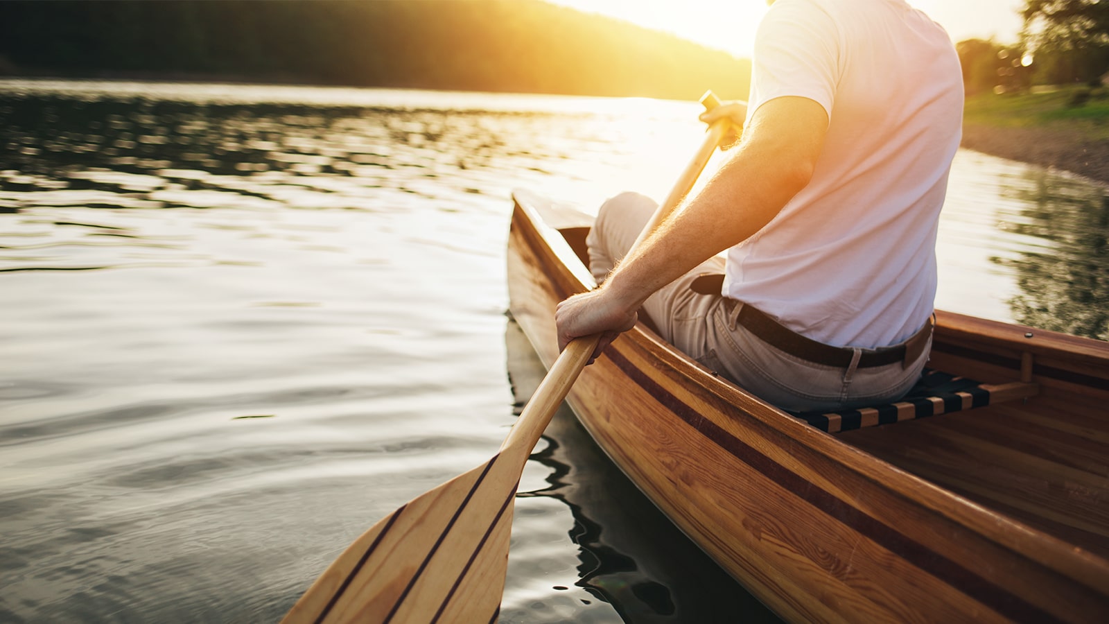 Man rowing canoe on water