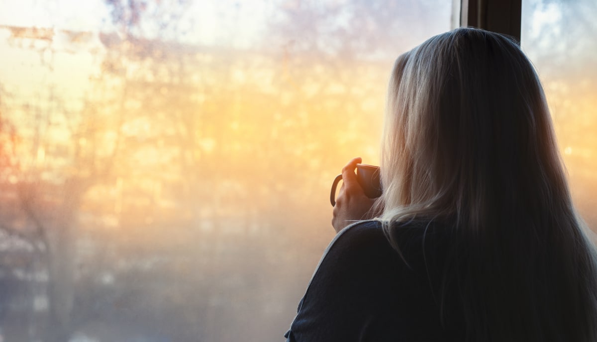 woman looking out a window