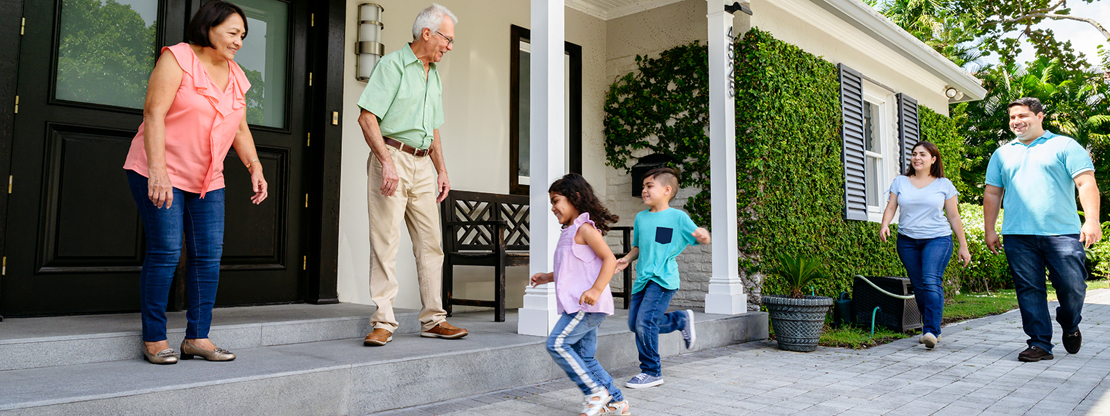 mutli-generation family greeting on front porch