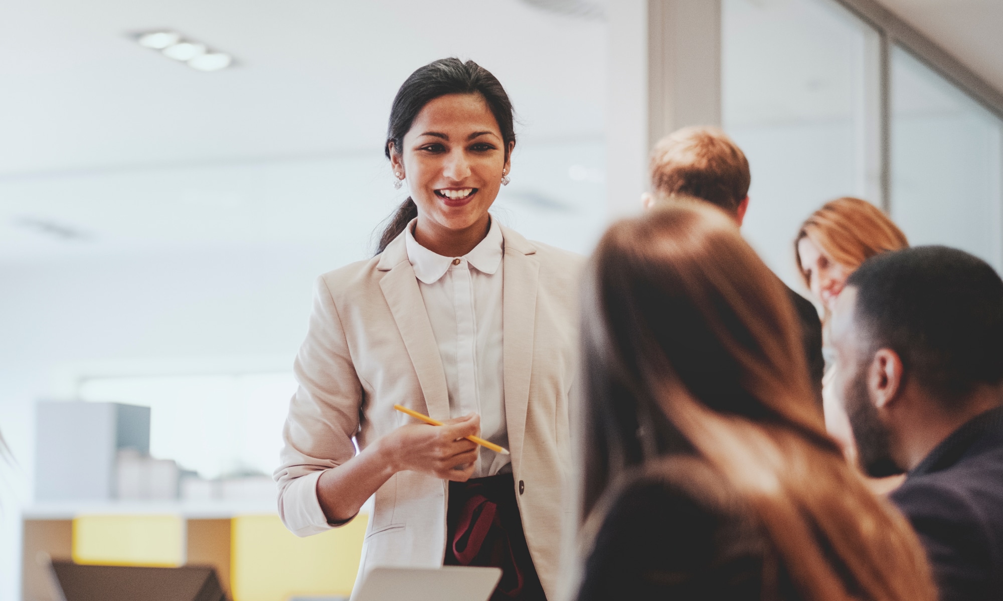 Women standing in front of a small group speaking