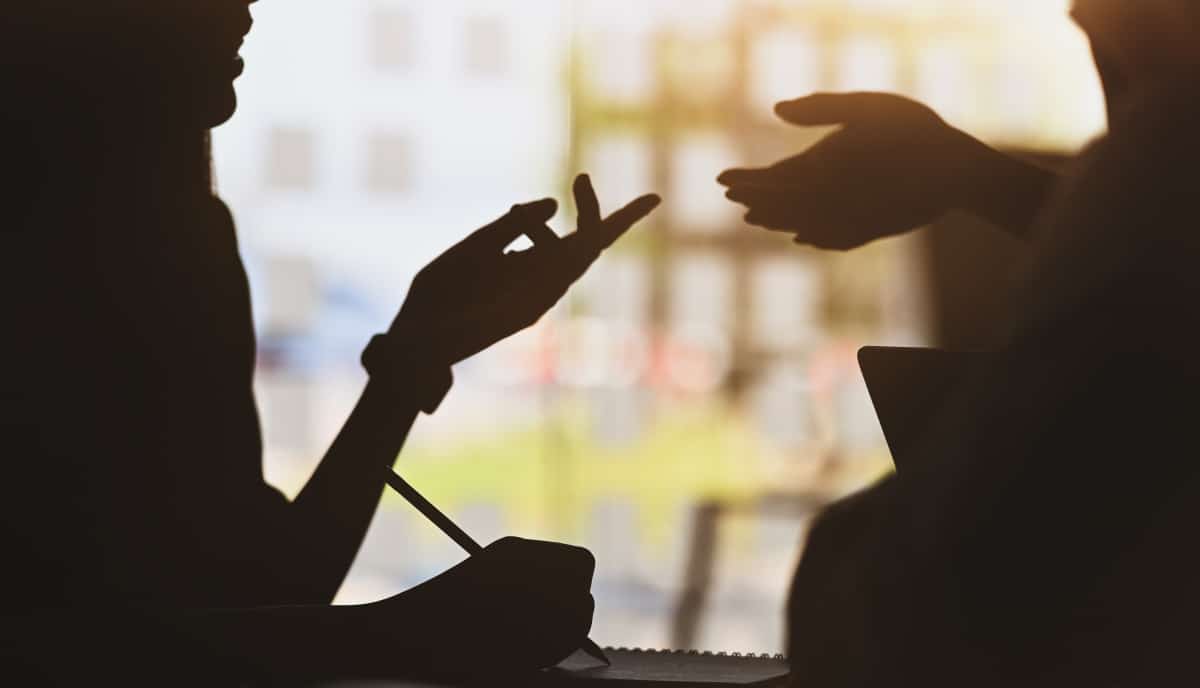 shadowed images of two people talking