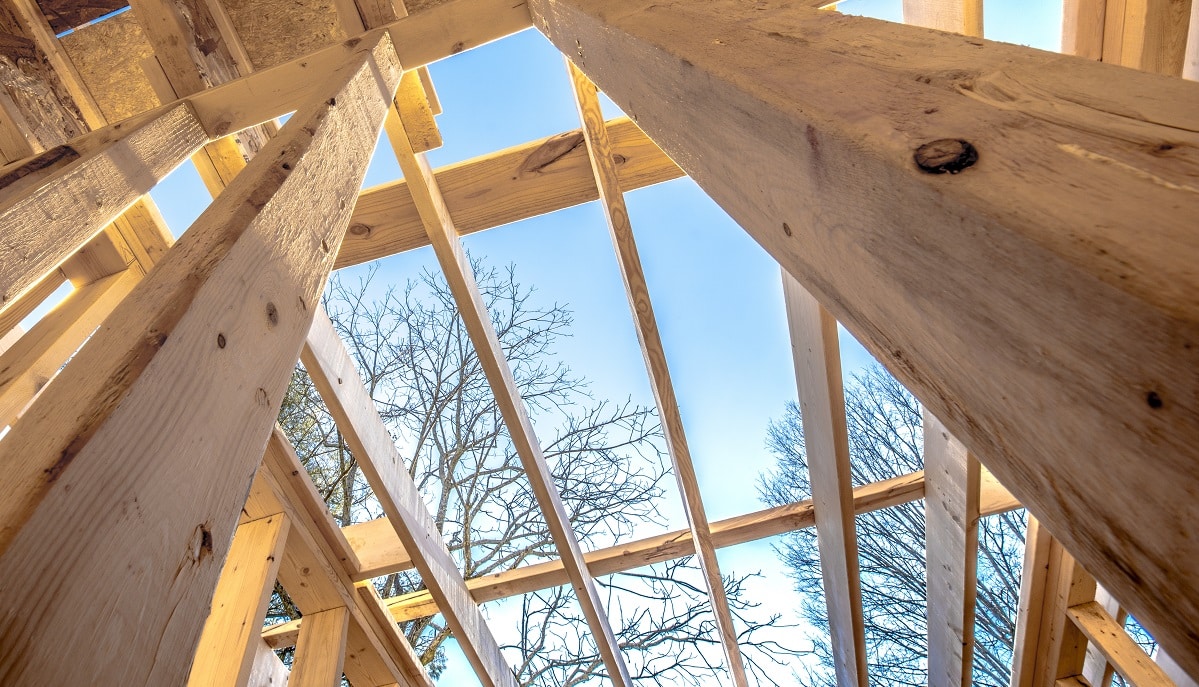 looking up to sky through a building construction